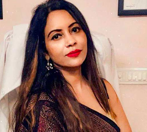 Dr. Poonam Arya sitting in her office chair